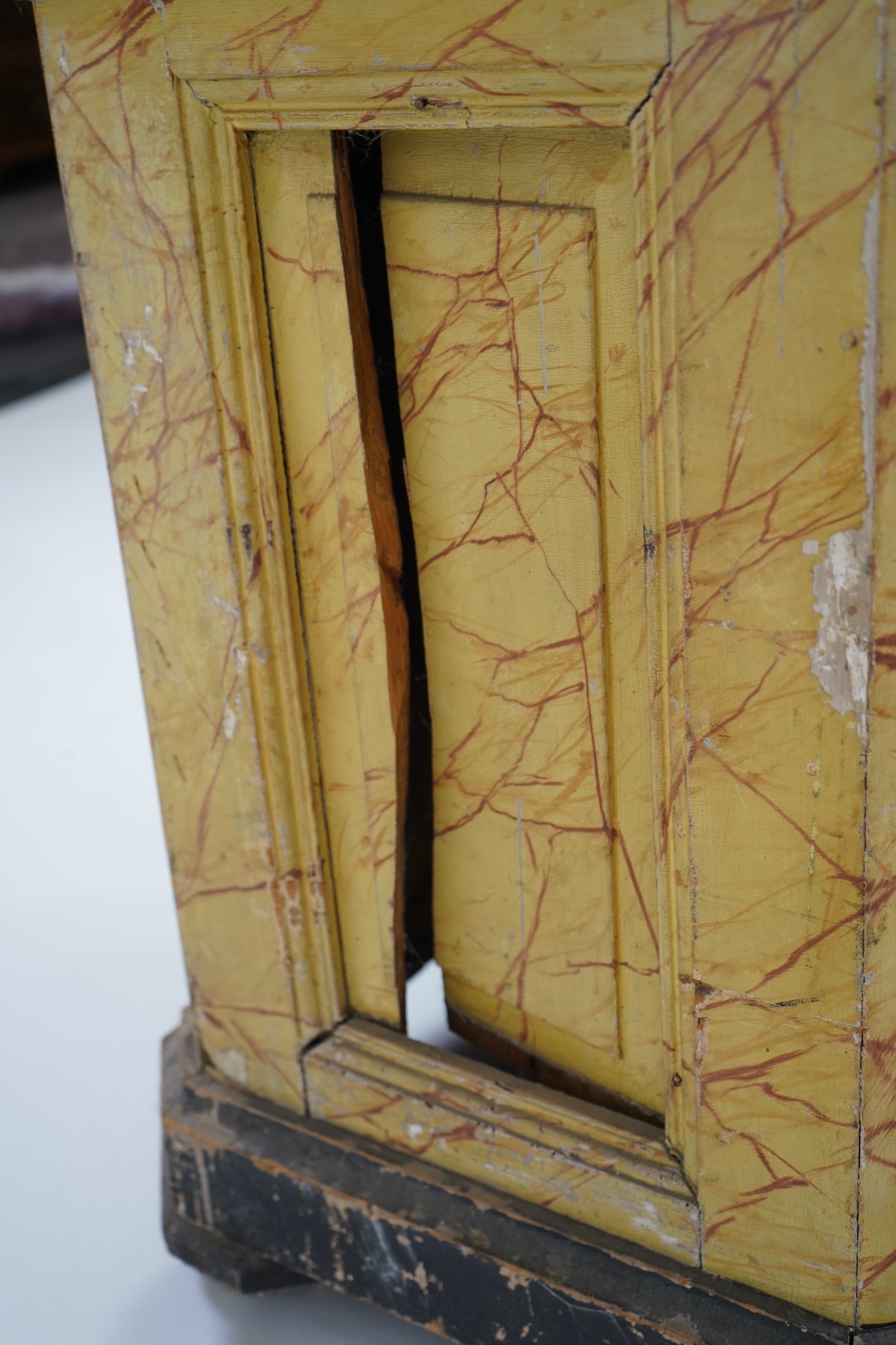 A Victorian white painted cast iron urn and a painted faux marble pedestal